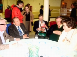 Friends at a table with Joe at the birthday party